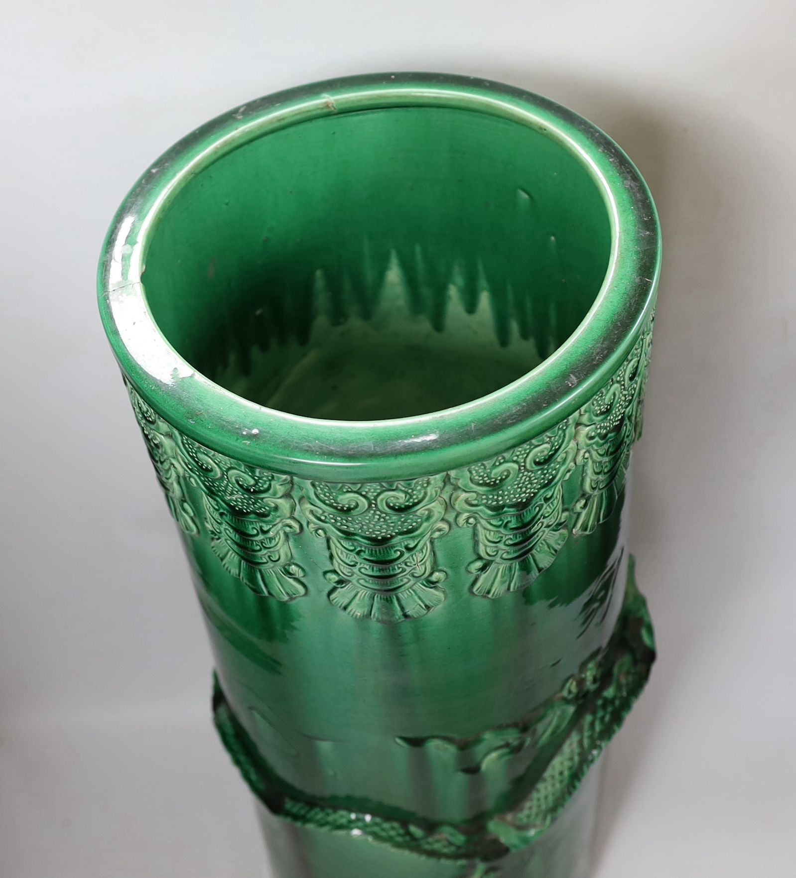 An early 20th century Japanese green glazed ‘dragon’ stick stand, 61cm